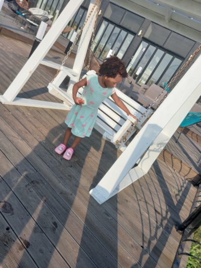 Quadrillionaire Baby Keilah on her swing bench at the Trott Bailey Family private island summer home