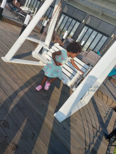 Quadrillionaire Baby Keilah on her swing bench at the Trott Bailey Family private island summer home