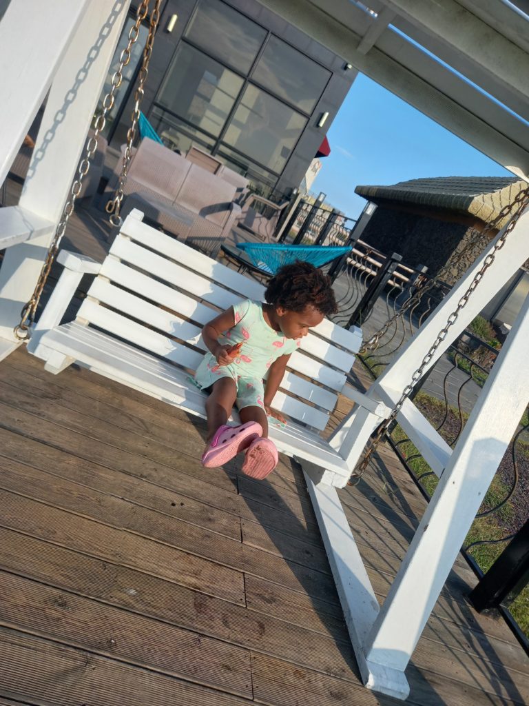 Quadrillionaire Baby Keilah on her swing bench at the Trott Bailey Family private island summer home