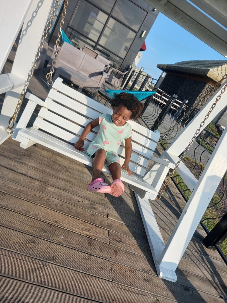 Quadrillionaire Baby Keilah on her swing bench at the Trott Bailey Family private island summer home