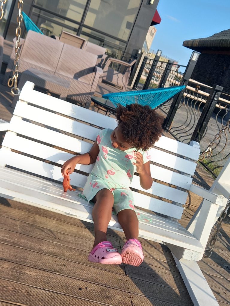 Quadrillionaire Baby Keilah on her swing bench at the Trott Bailey Family private island summer home