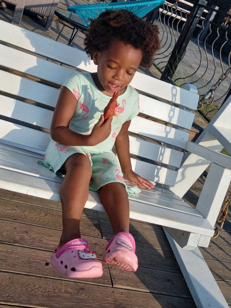 Quadrillionaire Baby Keilah on her swing bench at the Trott Bailey Family private island summer home