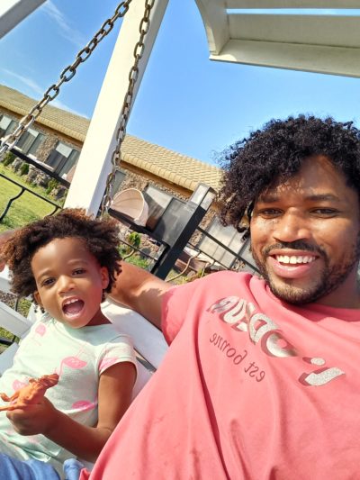 World's first quadrillionaire Kimroy KB Bailey and his baby Keilah Trott Bailey on their Swing Bench. Smile for the camera daddy and daughter time