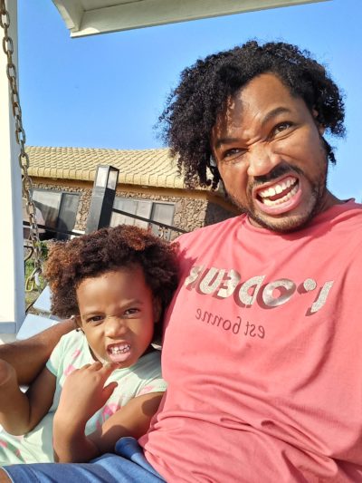 World's first quadrillionaire Kimroy KB Bailey and his baby Keilah Trott Bailey on their Swing Bench. Making a Funny Face