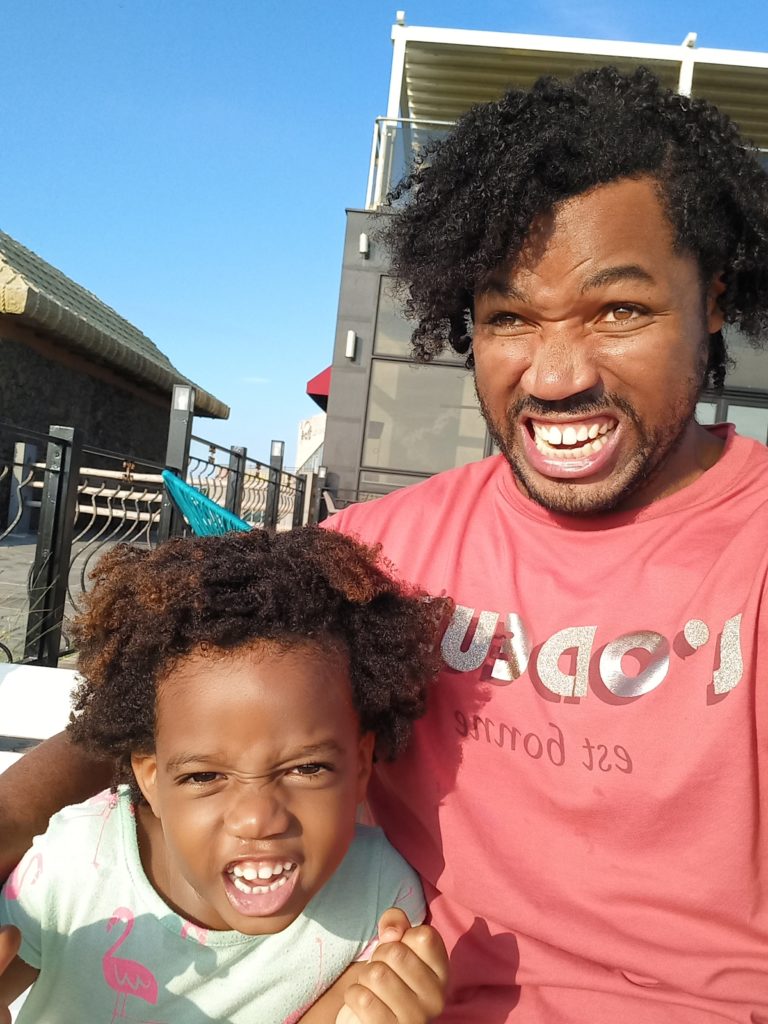 World's first quadrillionaire Kimroy KB Bailey and his baby Keilah Trott Bailey on their Swing Bench. Making a Funny Face