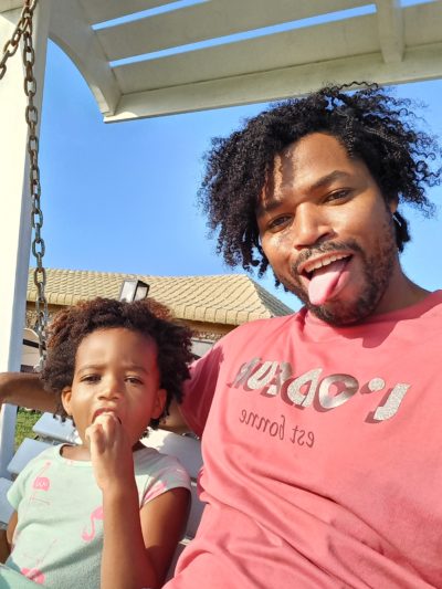 World's first quadrillionaire Kimroy KB Bailey and his baby Keilah Trott Bailey on their Swing Bench. Goofy face
