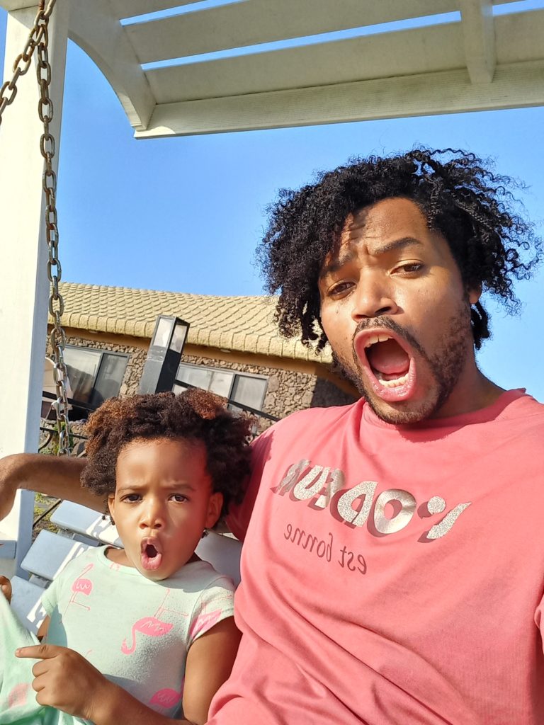 World's first quadrillionaire Kimroy KB Bailey and his baby Keilah Trott Bailey on their Swing Bench. Surprised Face