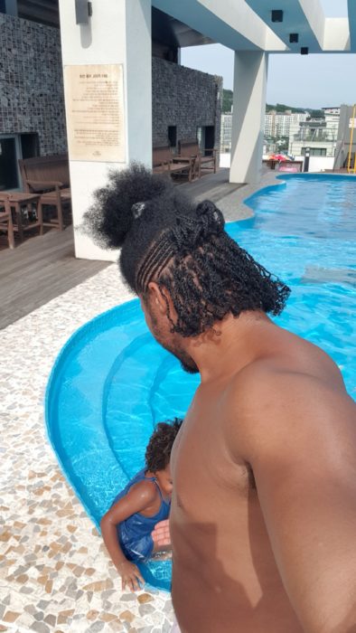 Quadrillionaire Kimroy KB Bailey showcases his new hairstyle and muscles at the poolside with Keilah Trott Bailey