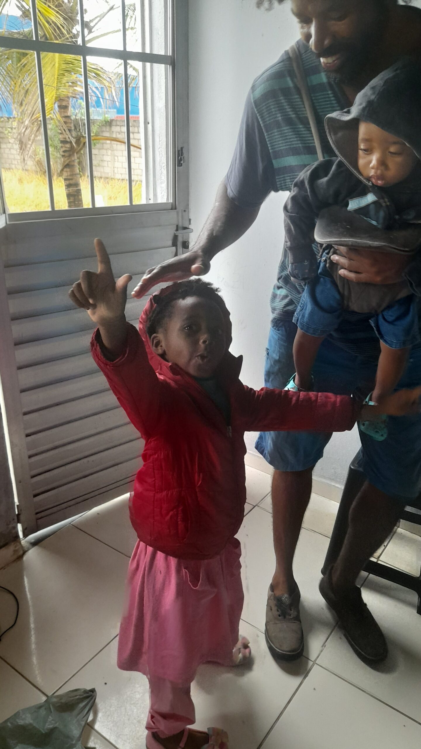 Kaleeyon and Kezidek in the hamper get ready to get drop off to school on a cold rainy morning with Big King Kimroy Bailey