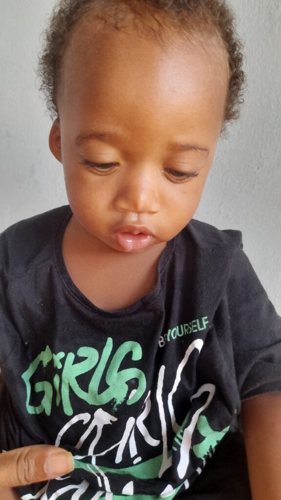 handsome young king kezidek in his black shirt sitting and looking down