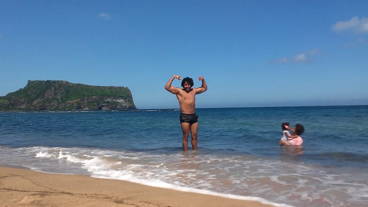 Kimroy Bailey flexing his amazing muscles for the camera at the Gwangchigi beach on Jeju Island, South Korea. While his darling wife Sher and princess Keilah played in the beach