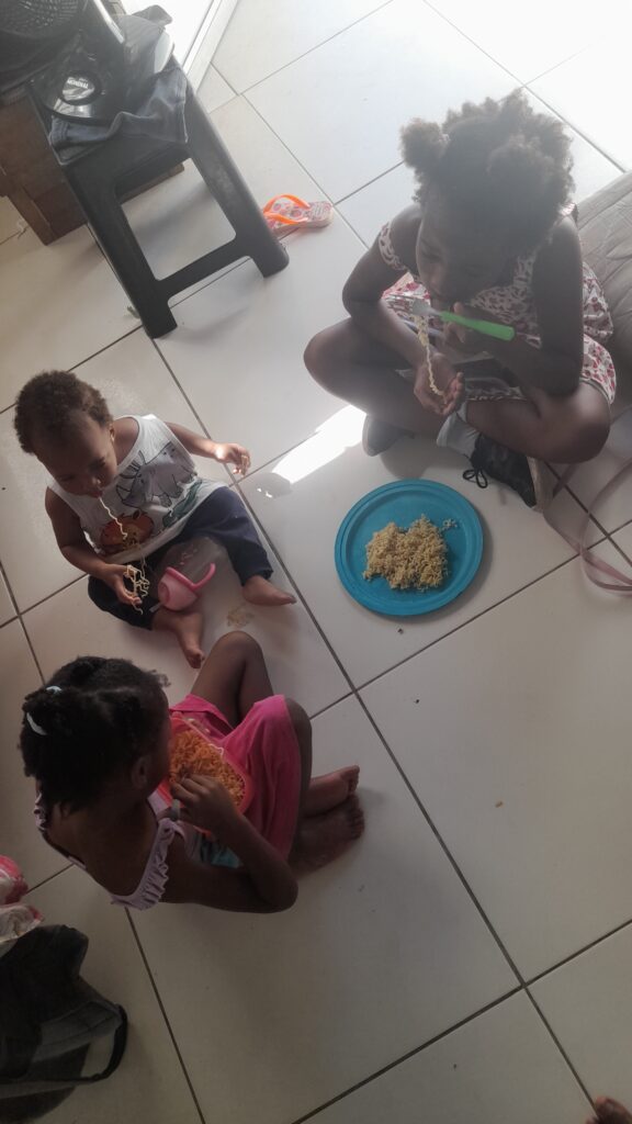 Three young children sit
