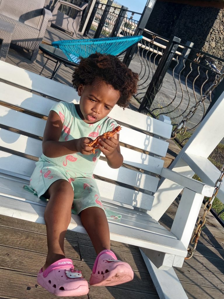 Quadrillionaire Baby Keilah on her swing bench at the Trott Bailey Family private island summer home